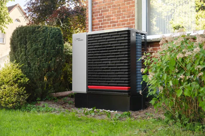 Heat pump outside a brick house